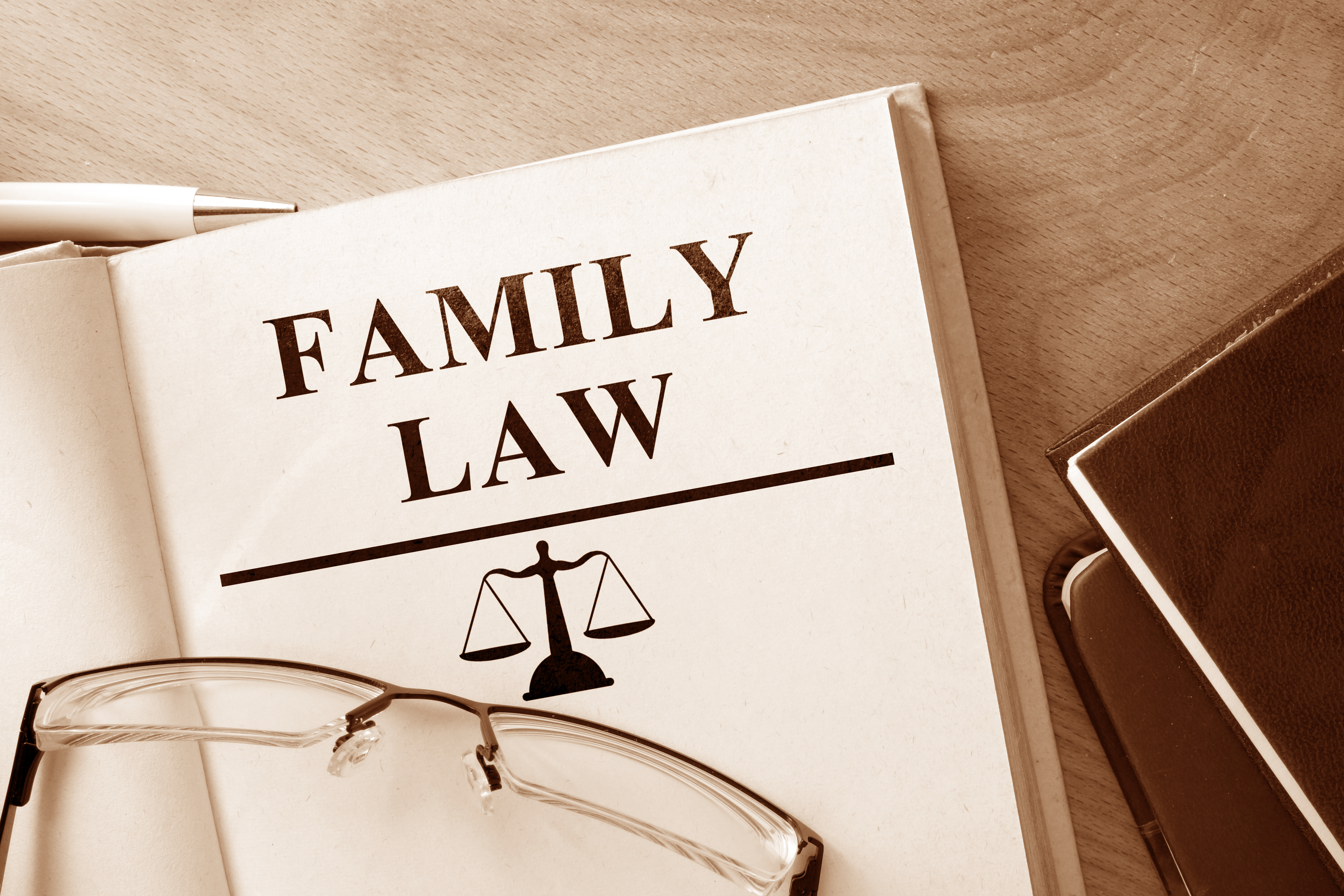 Book with words family law and glasses.